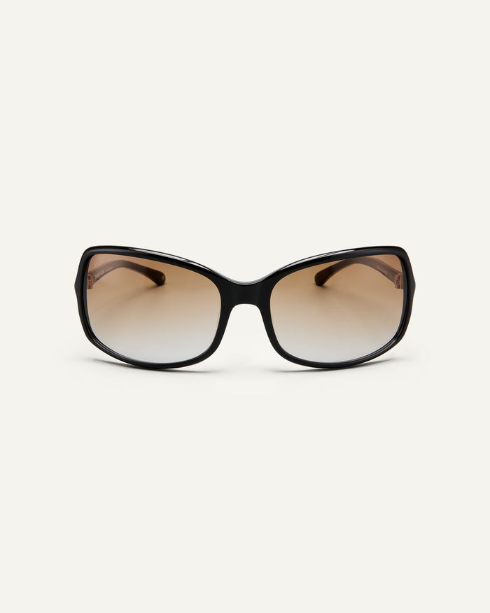 Black, rounded square sunglasses with brown gradient lenses on a white background