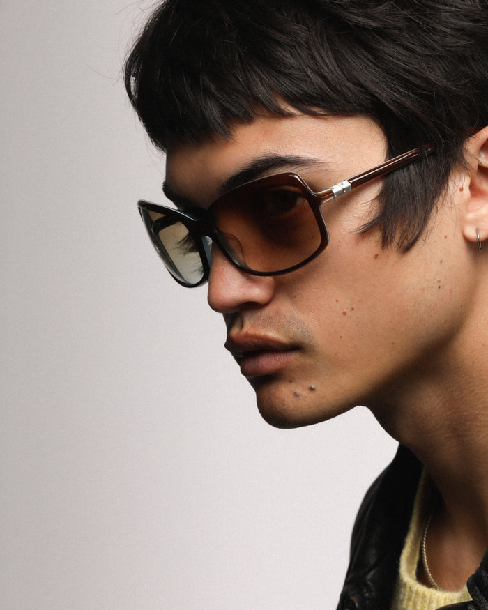 Side shot of Bonnie Clyde Body rounded square sunglasses in teal demi with brown lenses.