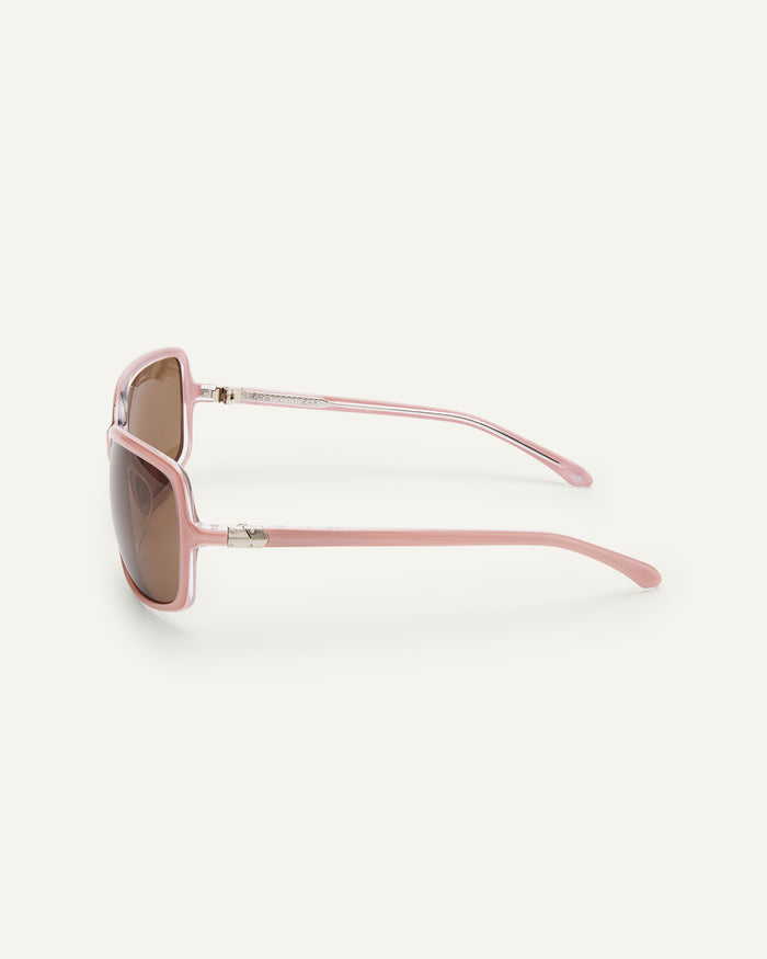Close-up shot of Bonnie Clyde Body rounded square sunglasses in layered pink with brown lenses.