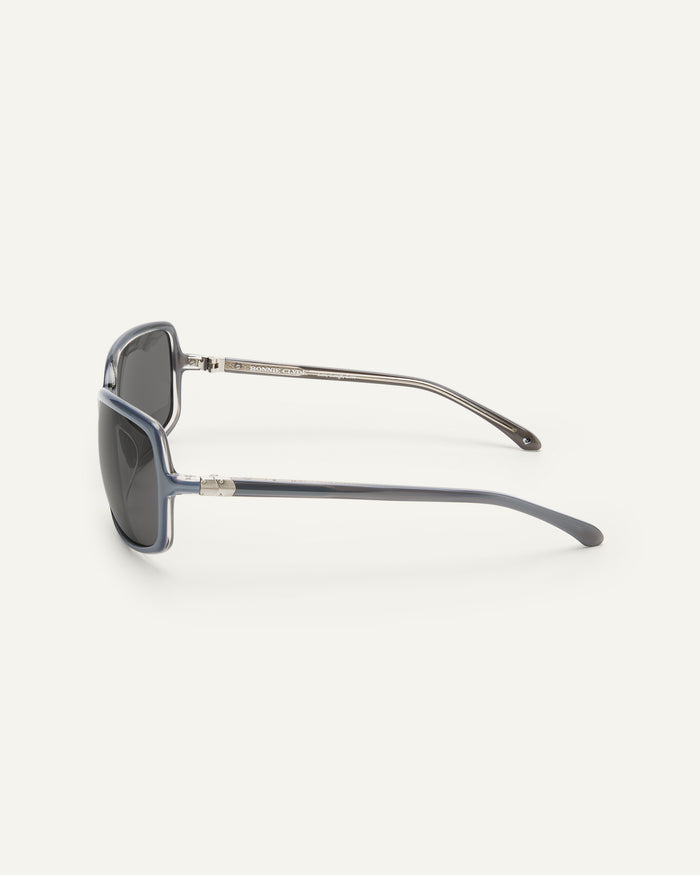 Close-up shot of Bonnie Clyde Body rounded square sunglasses in layered silver with black lenses.