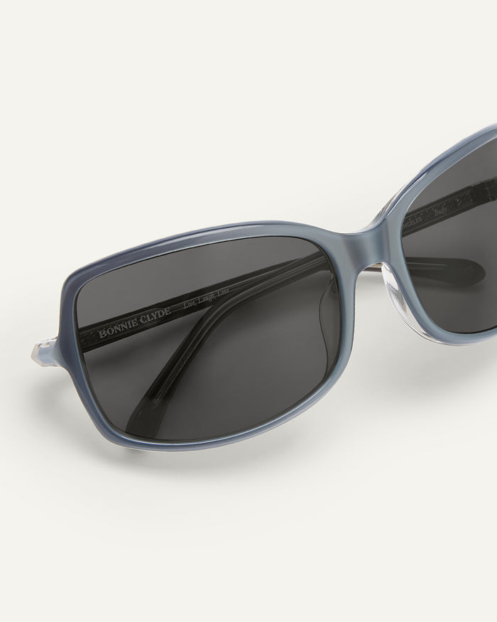 Detail shot of Bonnie Clyde Body rounded square sunglasses in layered silver with black lenses.