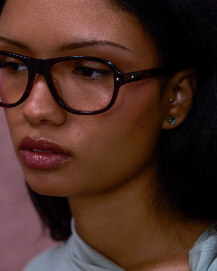 Close-up shot of Bonnie Clyde Boss Fight optical frames in red tortoise with clear lenses.