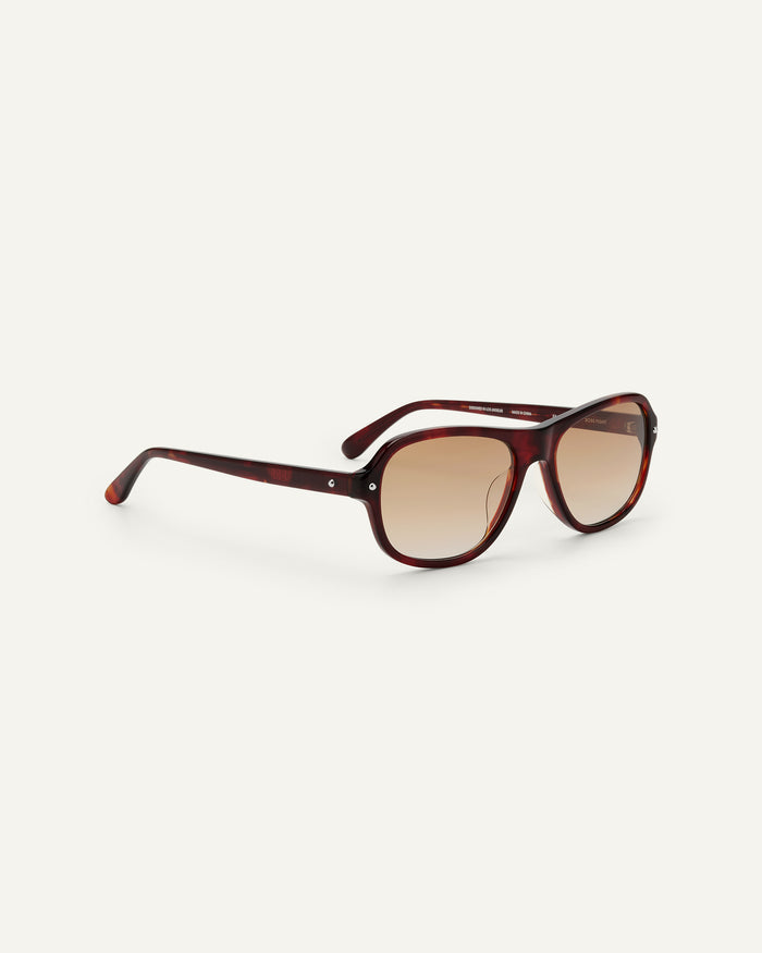 Close-up shot of Bonnie Clyde Boss Fight sunglasses in red tortoise with brown lenses.