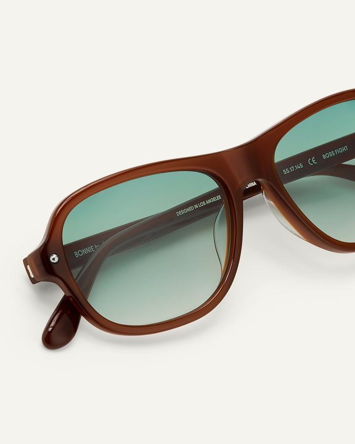 Close-up shot of Bonnie Clyde Boss Fight sunglasses in brown with green lenses.