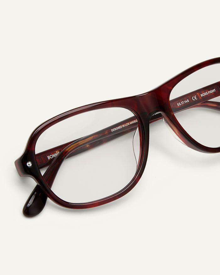 Detail shot of Bonnie Clyde Boss Fight optical frames in red tortoise with clear lenses.