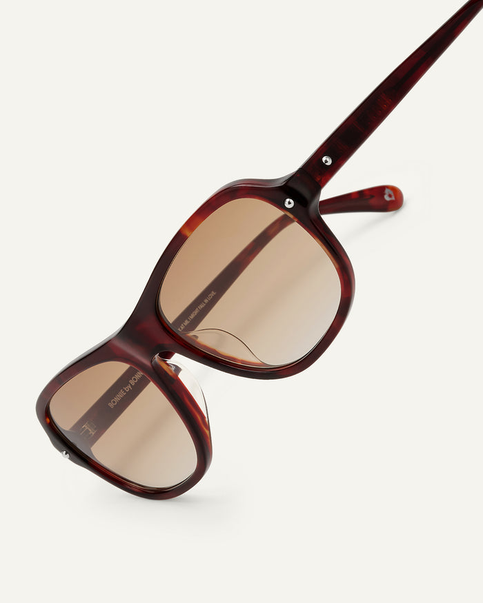 Detail shot of Bonnie Clyde Boss Fight sunglasses in red tortoise with brown lenses.