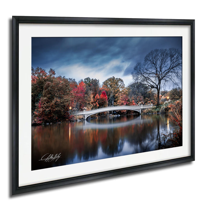 a serene landscape with a white bridge spanning a calm river, surrounded by a vibrant display of autumn foliage.