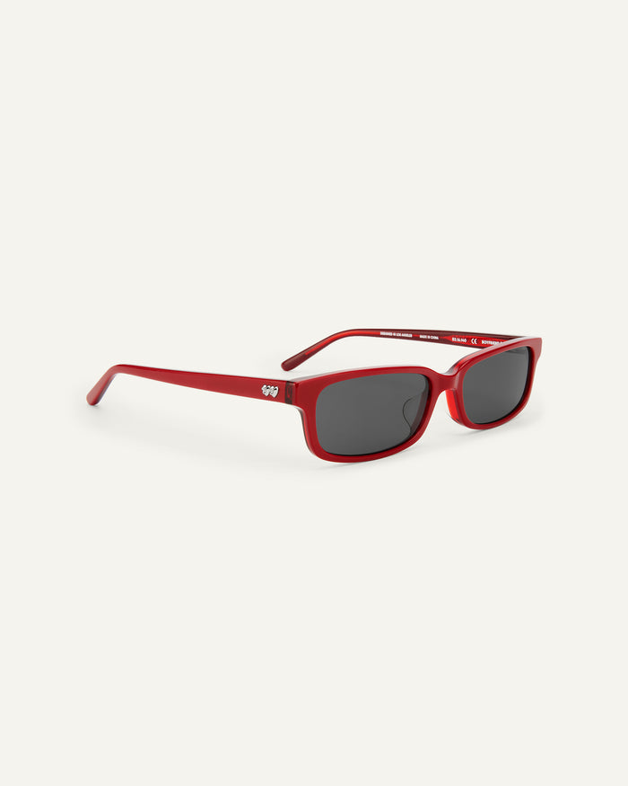 Quarter shot of Bonnie Clyde Boyfriend 2 sunglasses in layered red with black lenses.