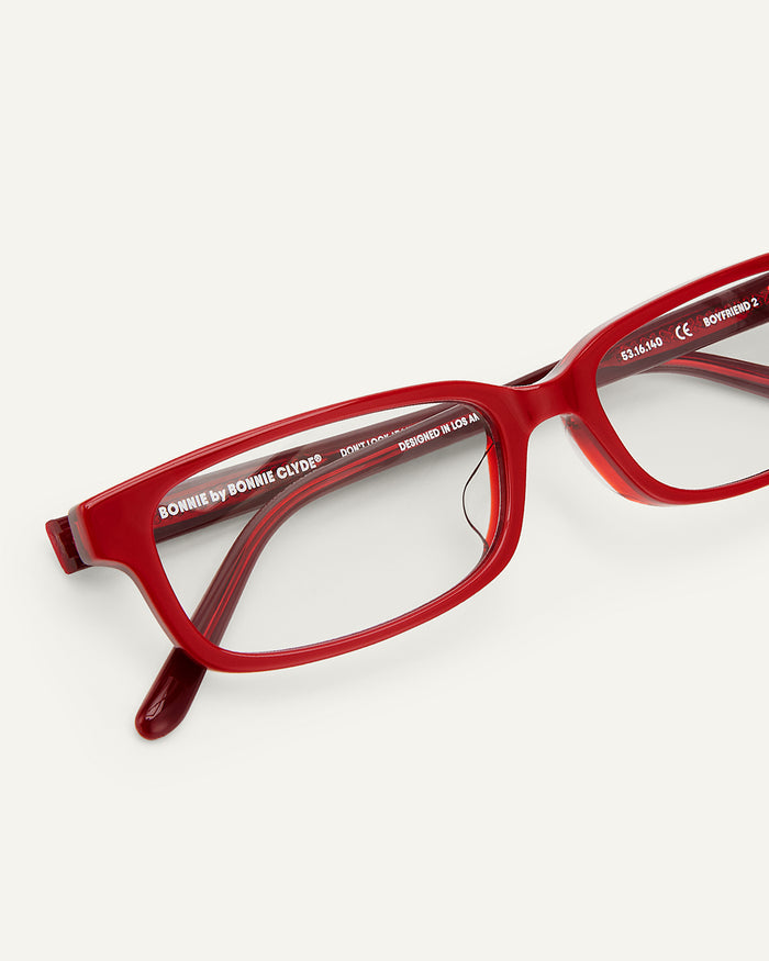 Side shot of Bonnie Clyde Boyfriend 2 optical frames in layered red with clear lenses.