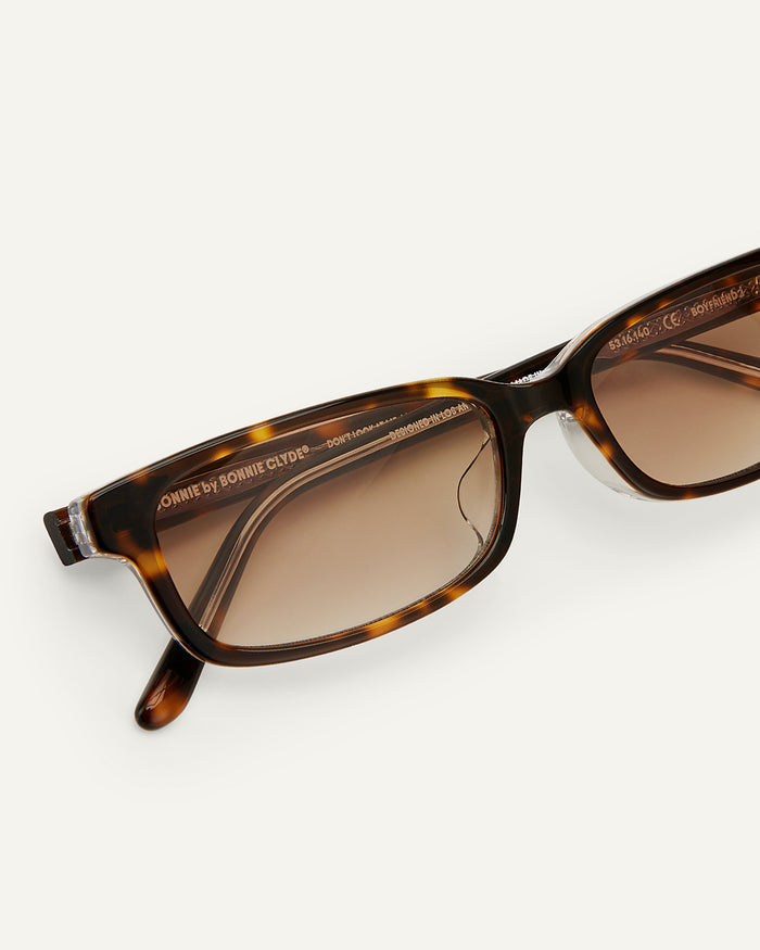 Close-up shot of Bonnie Clyde Boyfriend 2 sunglasses in layered tortoise with brown gradient lenses.