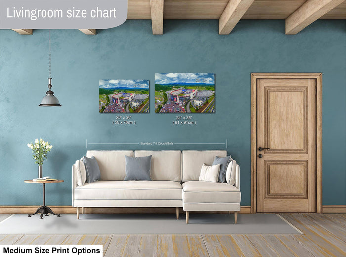 a living room with a white sofa, a wooden door, and a painting of a building on the wall. The painting is of a medium size, and the sofa is of a standard size. The living room appears to be well-decorated with a vase of flowers on a table.
