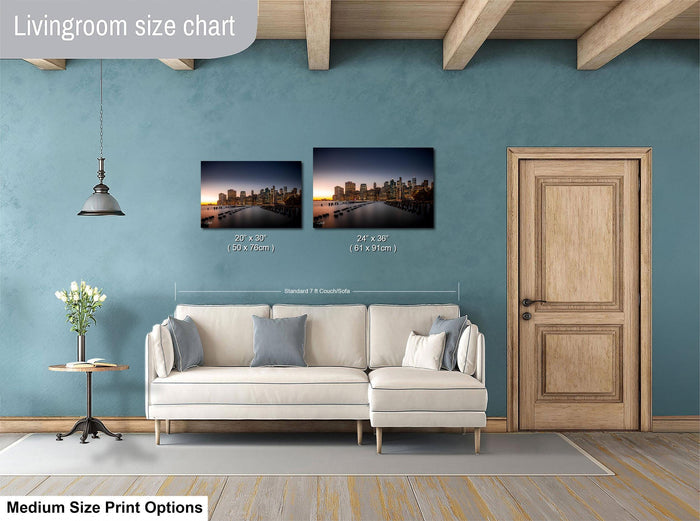 a living room with a white sofa, a wooden door, and a painting of a city skyline on the wall. The painting is of medium size, and the living room appears to be designed for a comfortable and relaxing atmosphere.