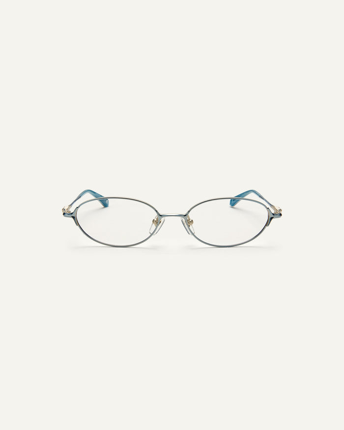 Face shot of Bonnie Clyde Bunny optical frames in stainless steel in layered blue with clear lens.