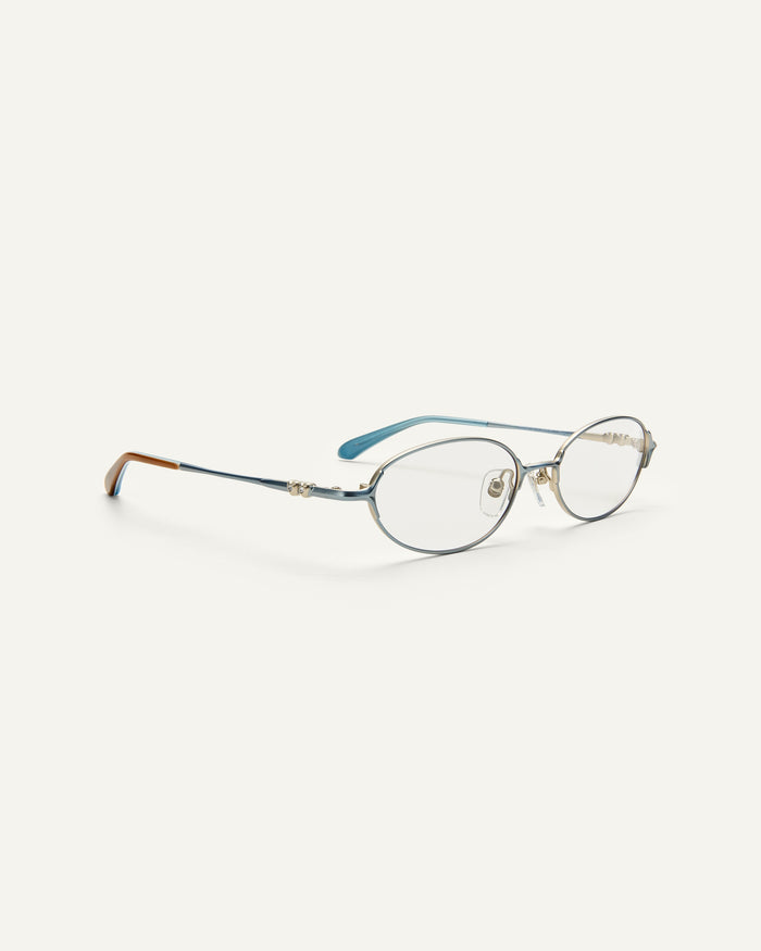 Quarter shot of Bonnie Clyde Bunny optical frames in stainless steel in layered blue with clear lens.