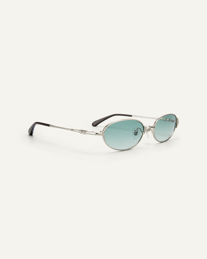 Quarter shot of Bonnie Clyde Bunny sunglasses in titanium silver and green lenses.