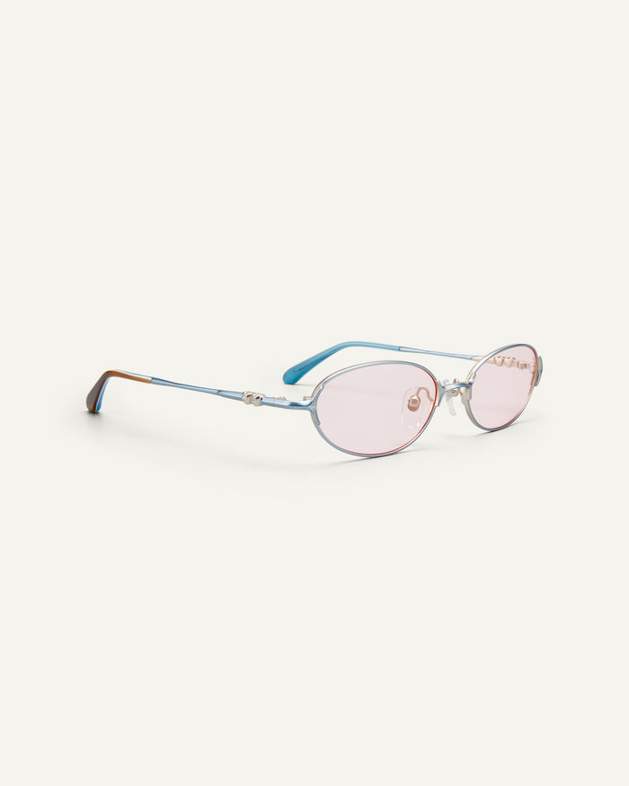 Quarter shot of Bonnie Clyde Bunny sunglasses in titanium silver and pink lenses.