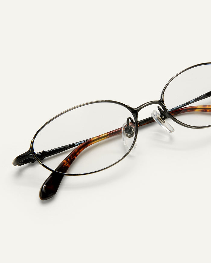 Close up shot of Bonnie Clyde Bunny optical frames in black stainless steel and clear lens.