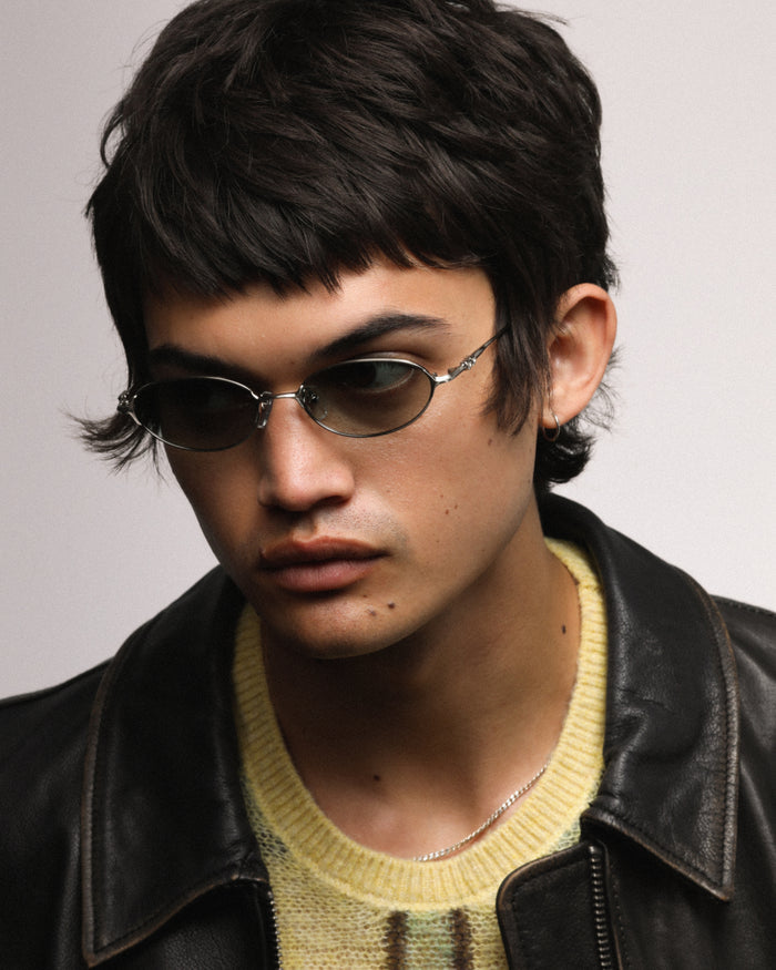 Detail shot of Bonnie Clyde Bunny sunglasses in titanium silver with green lenses.