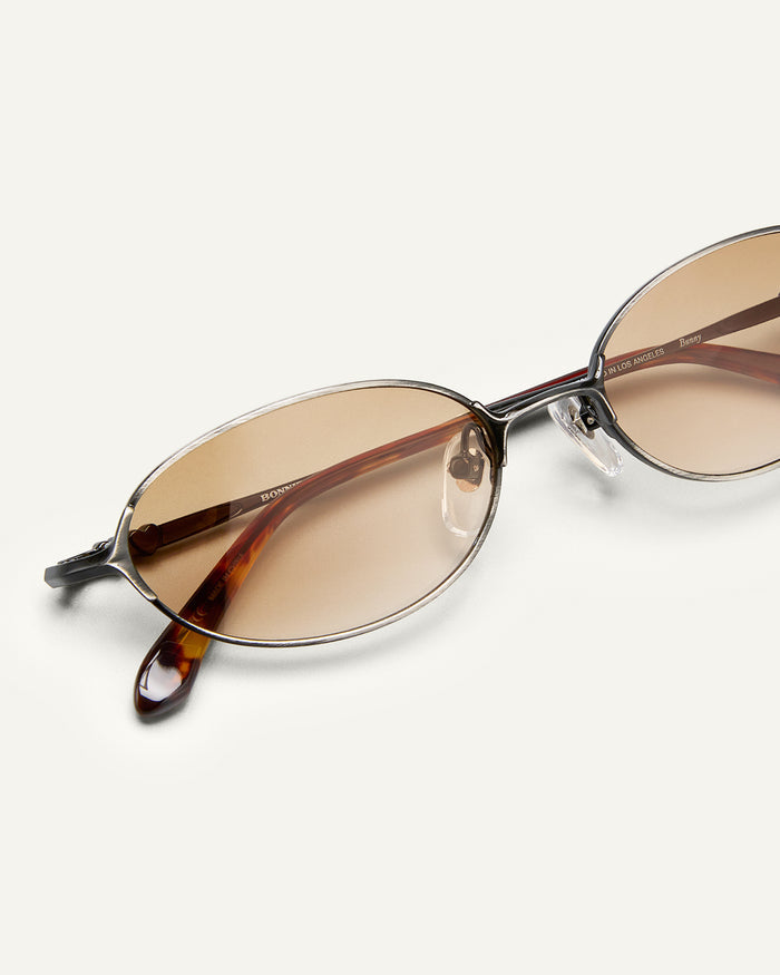 Close up shot of Bonnie Clyde Bunny sunglasses in black titanium with brown gradient lenses.