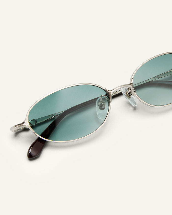 Close up shot of Bonnie Clyde Bunny sunglasses in titanium silver and green lenses.