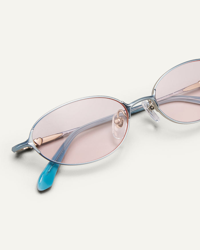 Close up shot of Bonnie Clyde Bunny sunglasses in titanium silver and pink lenses.