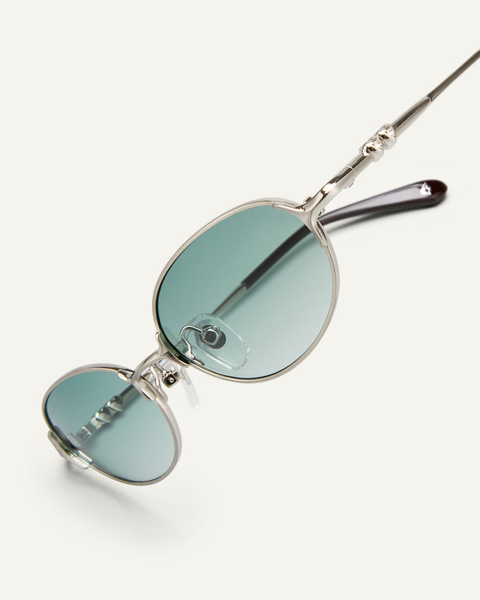 Side shot of Bonnie Clyde Bunny sunglasses in titanium silver and green lenses.