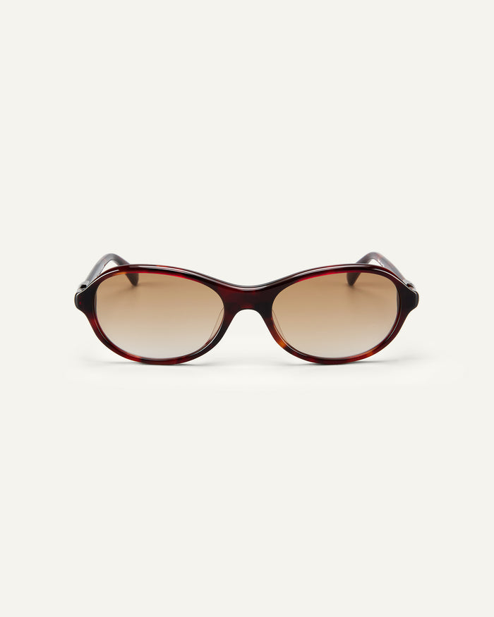 Face shot of Bonnie Clyde Butter Knife sunglasses in red tortoise with brown lenses.