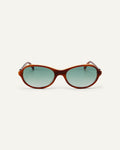 Face shot of Bonnie Clyde Butter Knife sunglasses in layered brown with green lenses.