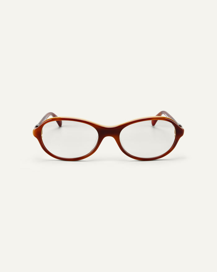 Face shot of Bonnie Clyde Butter Knife optical frames in layered brown with clear lenses.