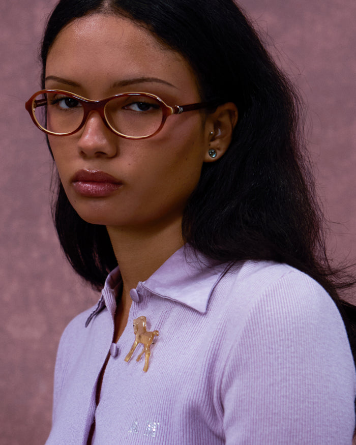 Quarter shot of Bonnie Clyde Butter Knife optical frames in layered brown with clear lenses.