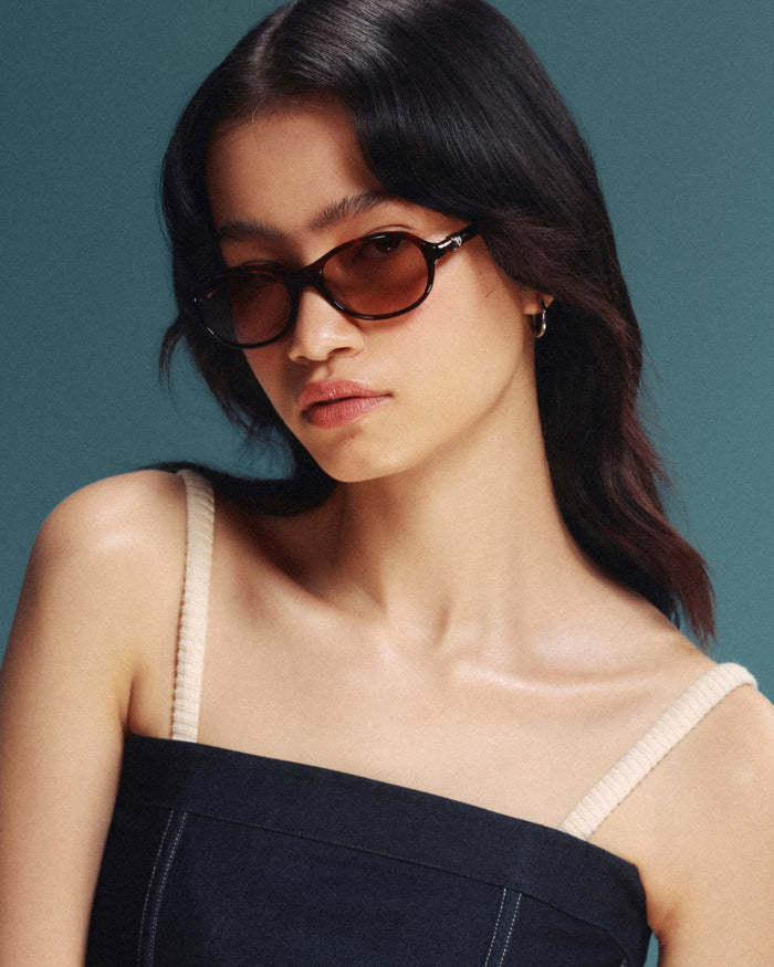 Quarter shot of Bonnie Clyde Butter Knife sunglasses in red tortoise with brown lenses.