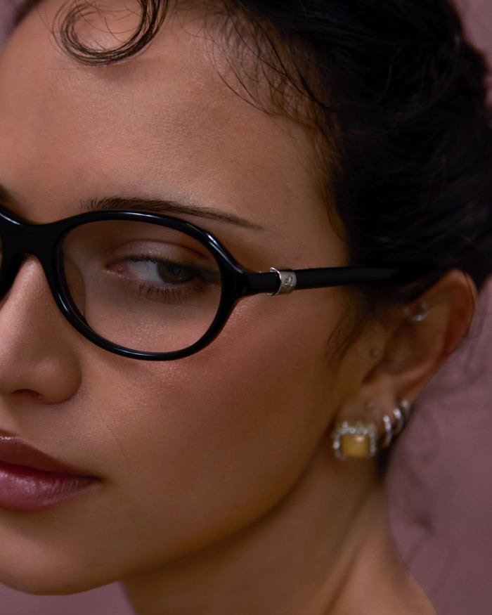 Quarter shot of Bonnie Clyde Butter Knife optical frames in black with clear lenses.