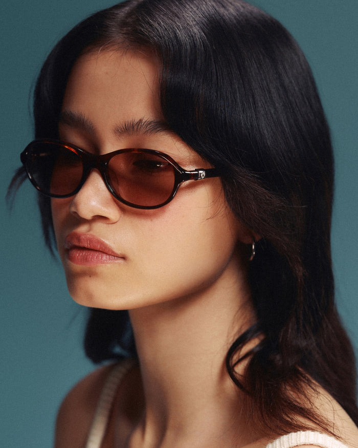 Side shot of Bonnie Clyde Butter Knife sunglasses in red tortoise with brown lenses.