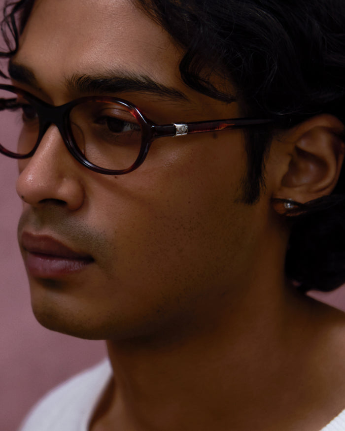 Close-up shot of Bonnie Clyde Butter Knife optical frames in red tortoise with clear lenses.