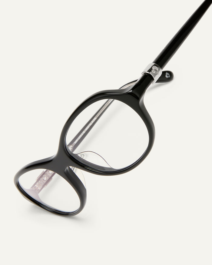 Close-up shot of Bonnie Clyde Butter Knife optical frames in black with clear lenses.