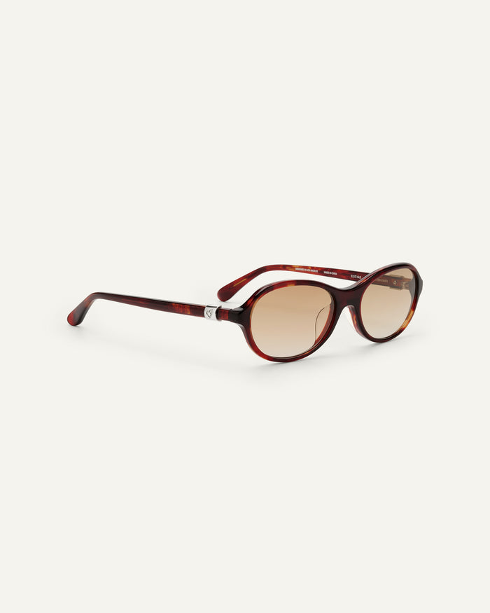 Close-up shot of Bonnie Clyde Butter Knife sunglasses in red tortoise with brown lenses.