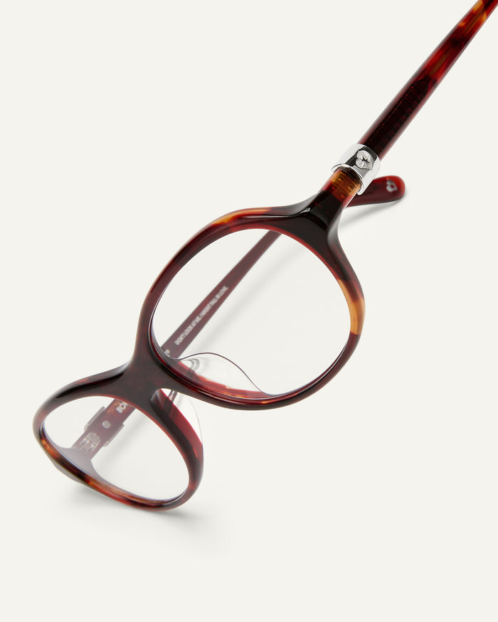 Detail shot of Bonnie Clyde Butter Knife optical frames in red tortoise with clear lenses.