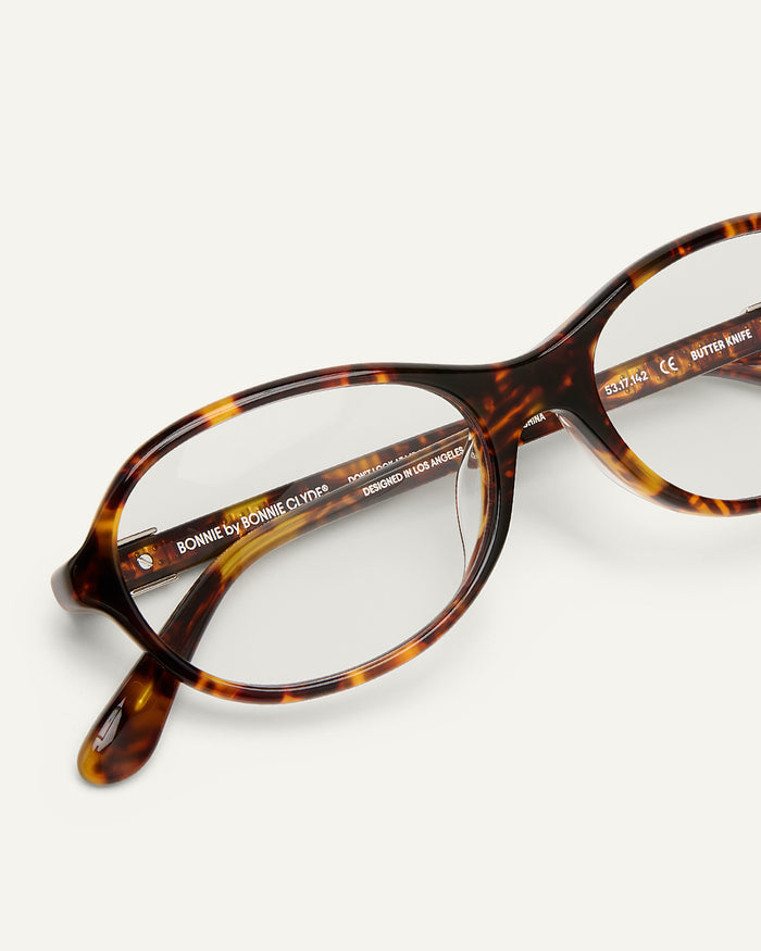 Detail shot of Bonnie Clyde Butter Knife optical frames in tortoise with clear lenses.