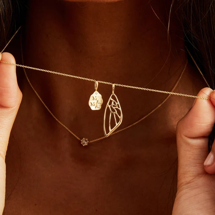 Butterfly Wing Charm in 10k yellow gold, shown worn on hand