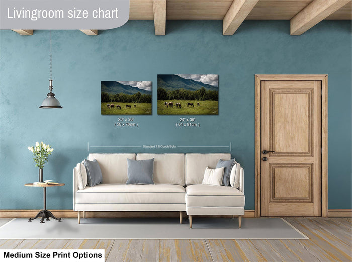 a living room with a white sofa, a wooden door, and a painting of a field with cows. The living room has a blue wall and a wooden ceiling.
