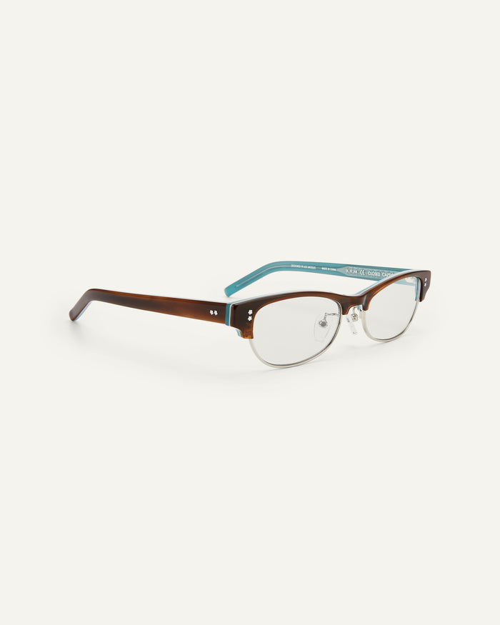Side shot of Bonnie Clyde CC optical frames in layered demi teal with clear lenses.