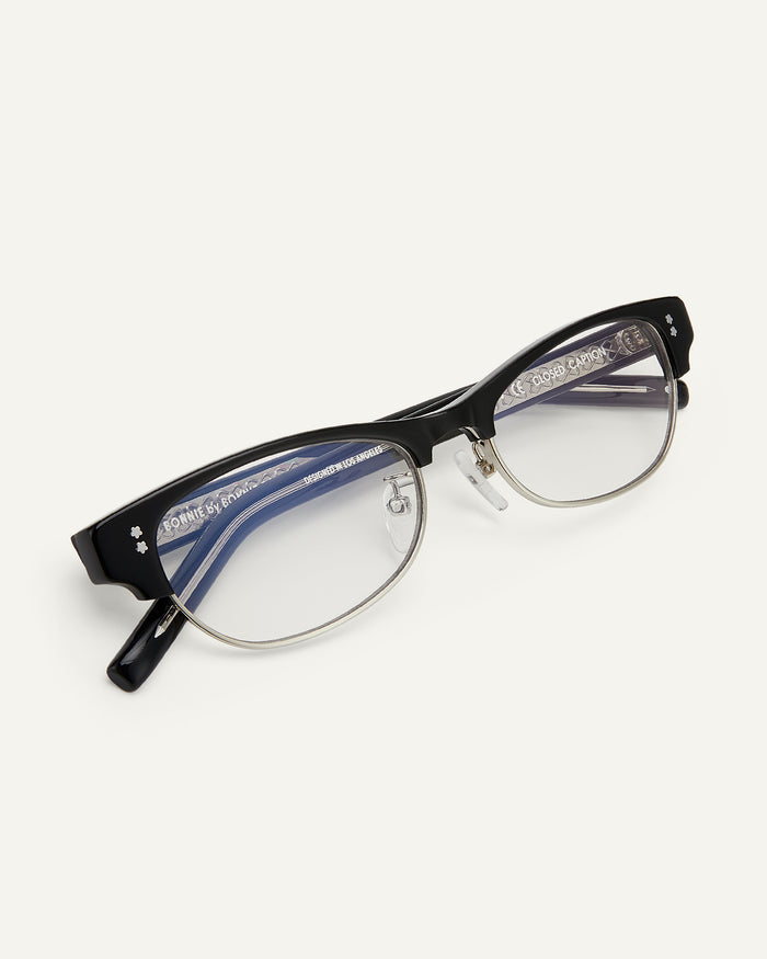 Close-up shot of Bonnie Clyde CC optical frames in black with clear lenses.