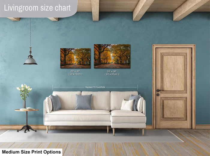 a living room with a white sofa, a wooden door, and a painting of a forest scene on the wall.