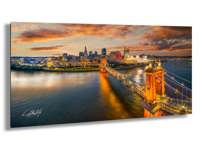 Cincinnati Ohio wall art, Ohio river aerial photography, urban skyline sunset print, Roebling bridge historic photo, Queen City home decor, Midwest travel wall art, Cincinnati sports stadiums photo, suspension bridge cityscape art, downtown Cincinnati aerial view, vibrant sunset city wall print, skyline over river fine art photo, architectural bridge photography, Cincinnati panoramic art print, Ohio city golden hour photo, Midwest urban skyline decor