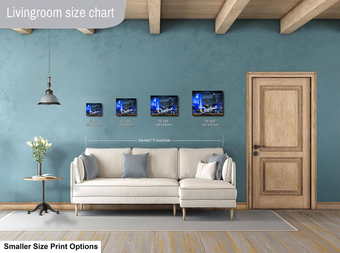 a living room with a white sofa, a wooden door, and a hanging light fixture. Above the sofa, there is a size chart displaying the dimensions of four framed artworks.