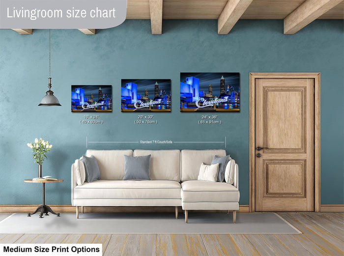 The image is a livingroom with a white sofa and a wooden door. Above the sofa, there is a livingroom size chart that provides the dimensions of three framed artworks hanging on the wall.
