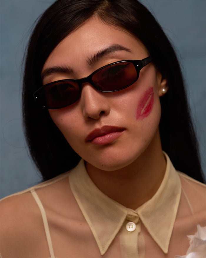 Quarter shot of Bonnie Clyde Coco sunglasses in black with brown lenses.