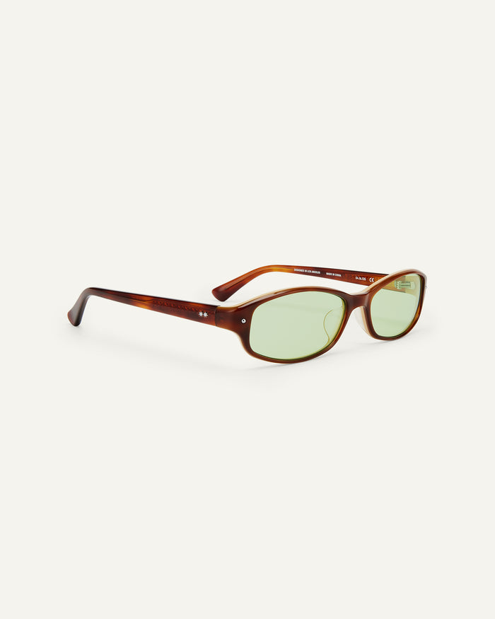 Quarter shot of Bonnie Clyde Coco sunglasses in layered brown with green lenses.