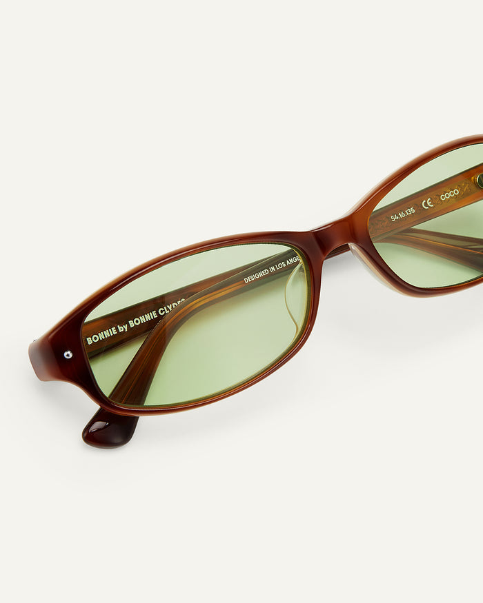 Side shot of Bonnie Clyde Coco sunglasses in layered brown with green lenses.