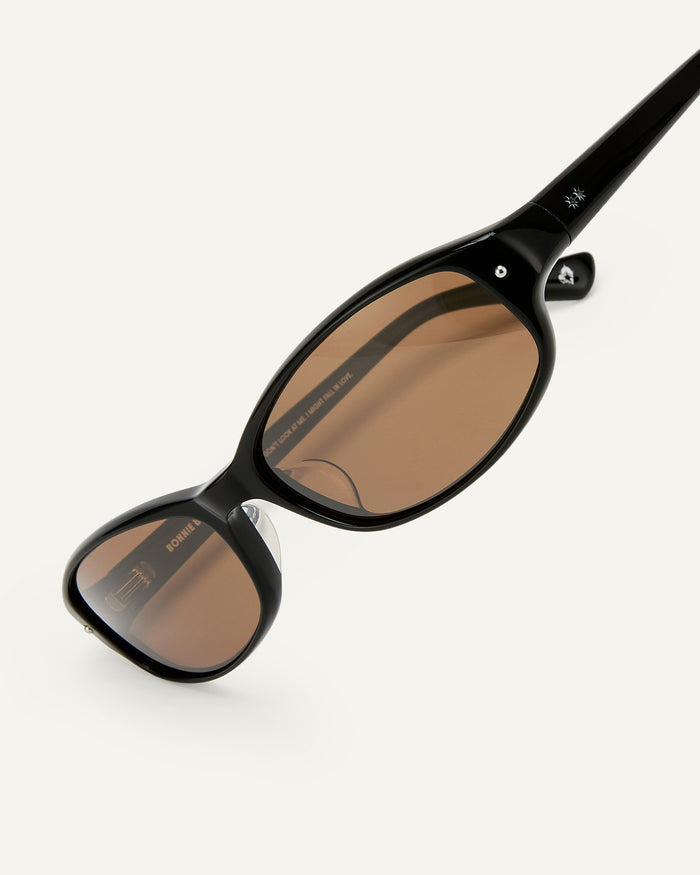 Close-up shot of Bonnie Clyde Coco sunglasses in black with brown lenses.